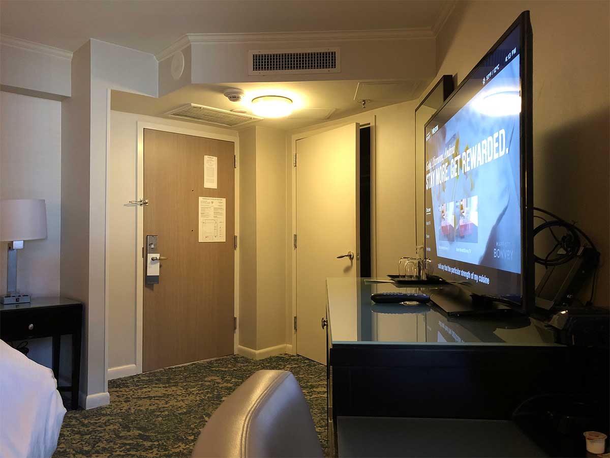 TV and hotel room door.