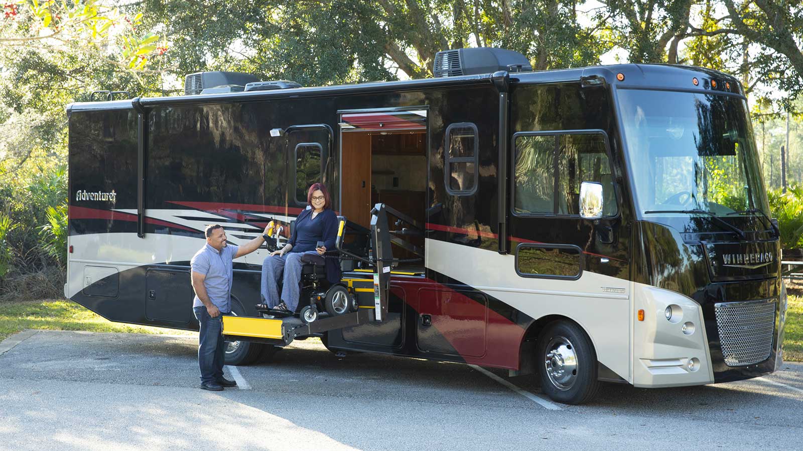 Exterior of Winnebago Adventurer with wheelchair lift deployed.