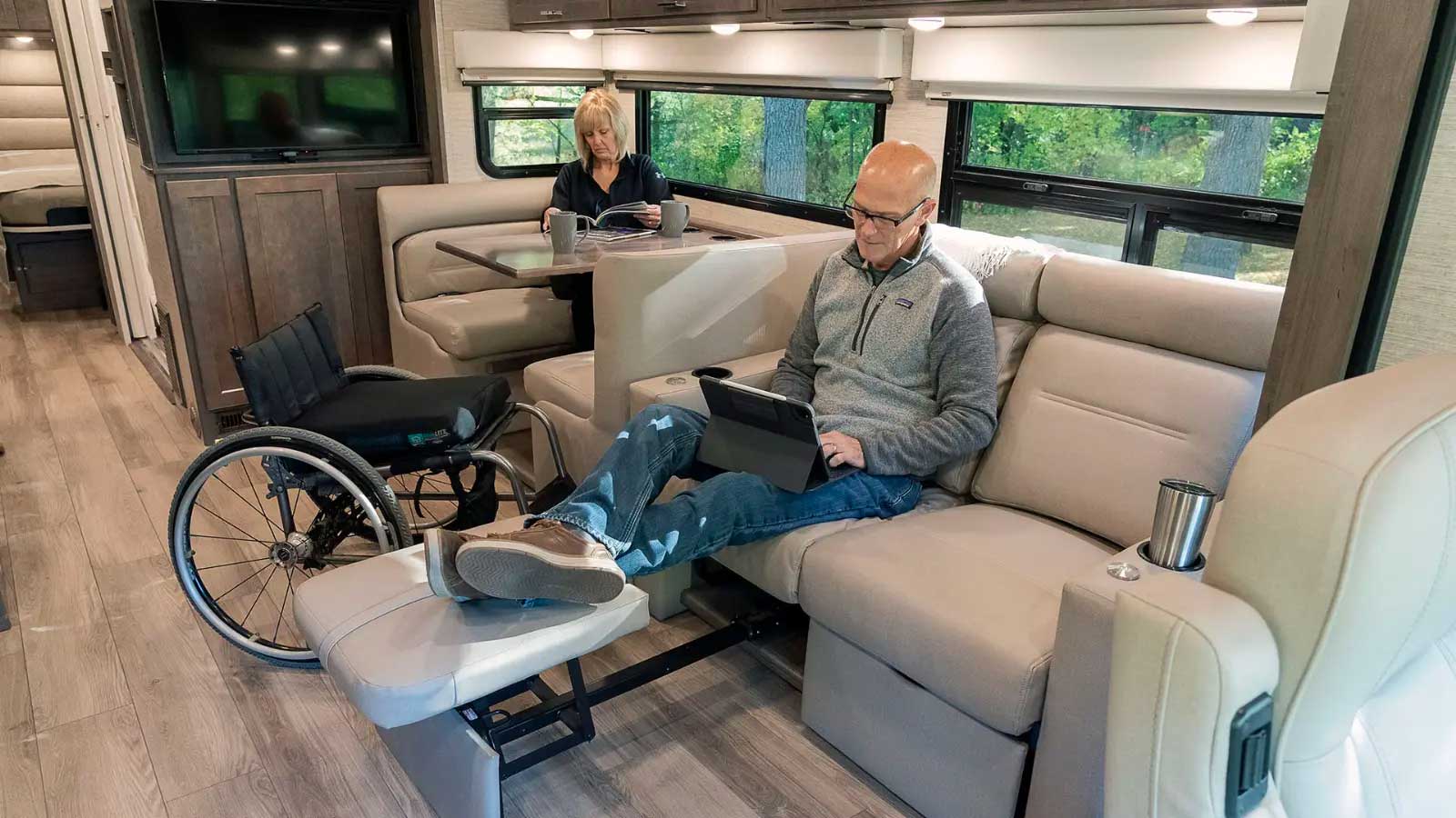 Wheelchair user seated on sofa.