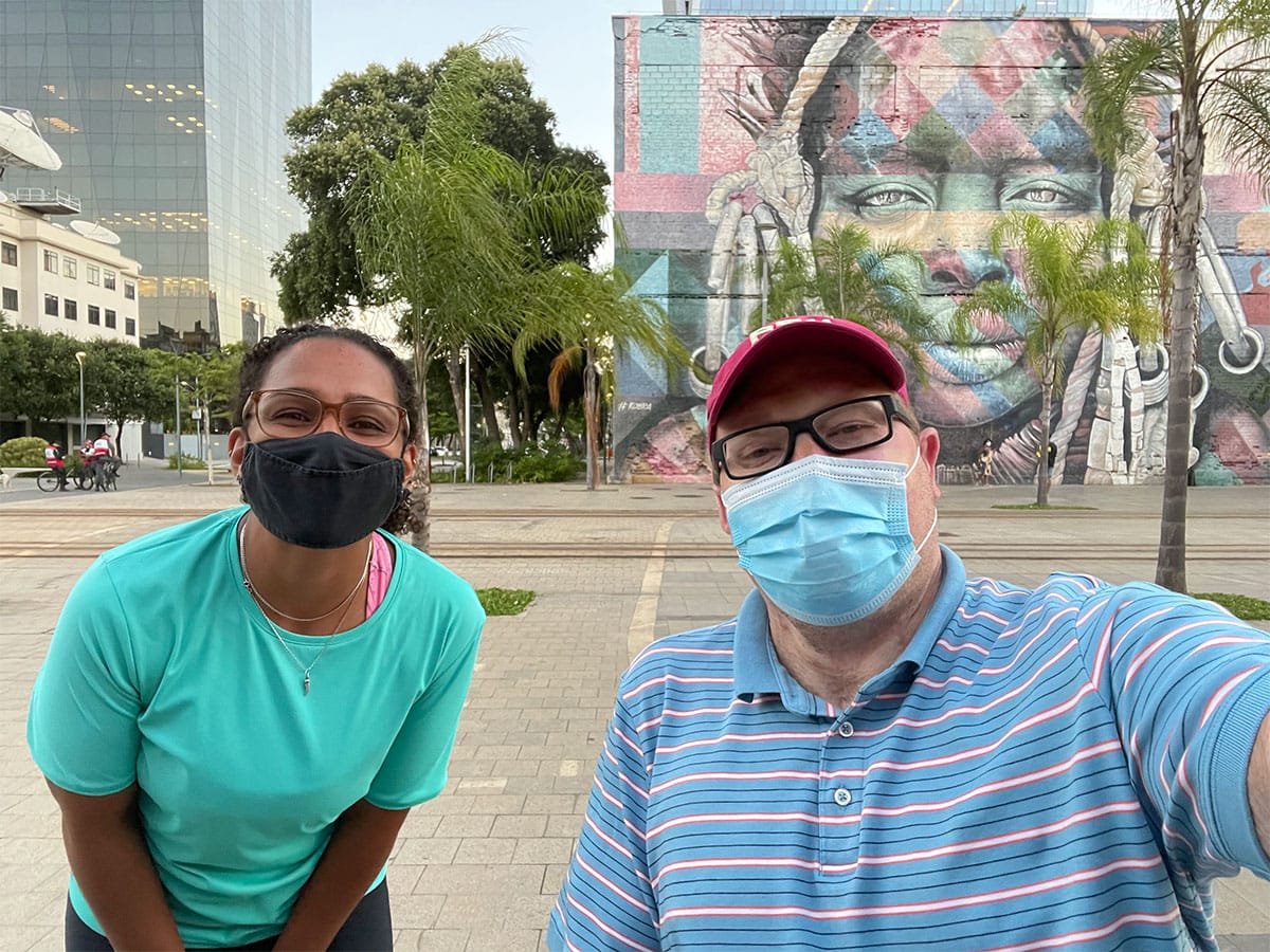 Selfie with tour guide in front of mural.