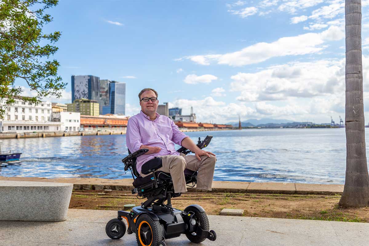 John rolling in his wheelchair in the city center.