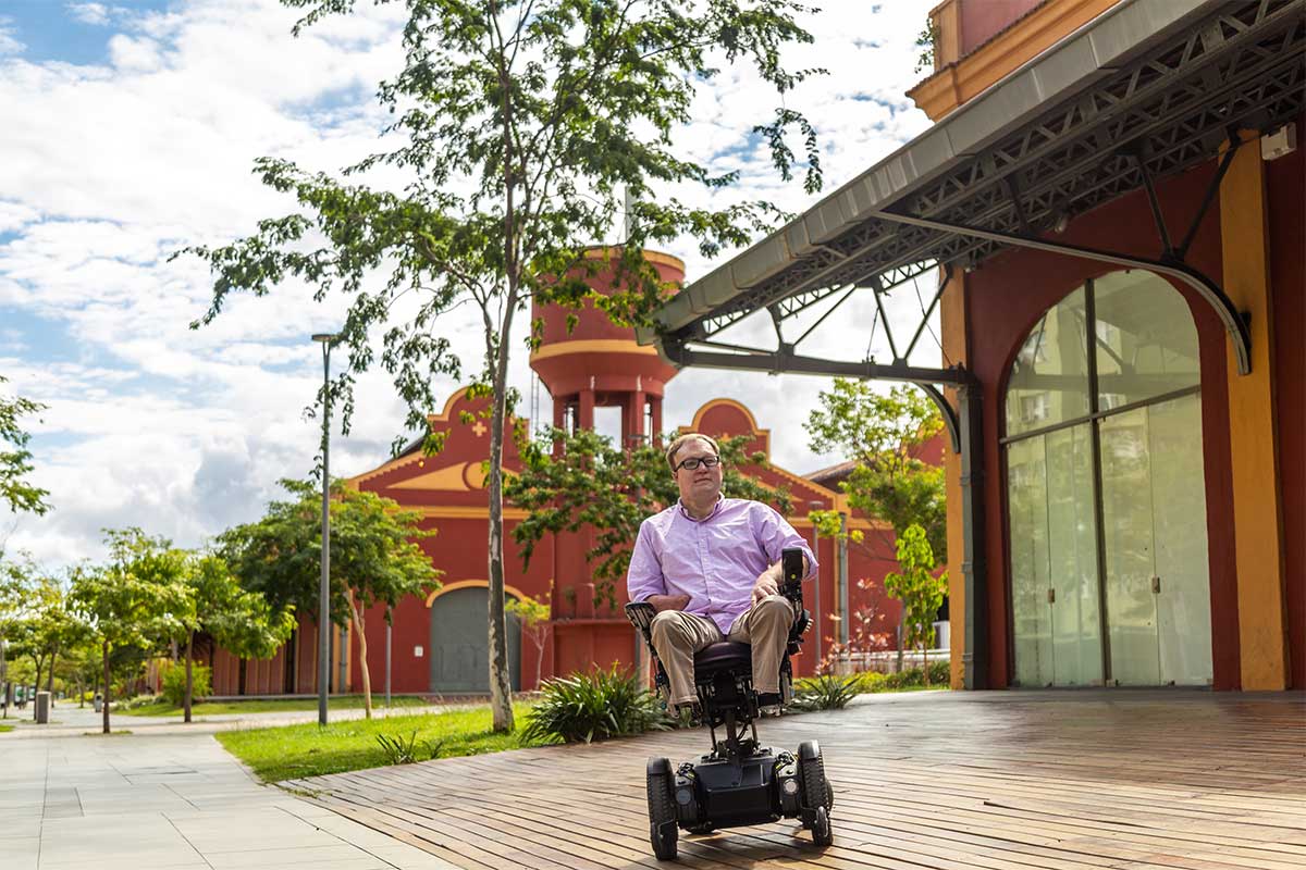 John rolling in his wheelchair along the cruise ship terminal area.