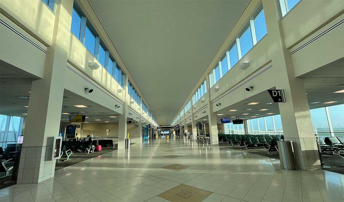 Terminal concourse with boarding gates on either side.