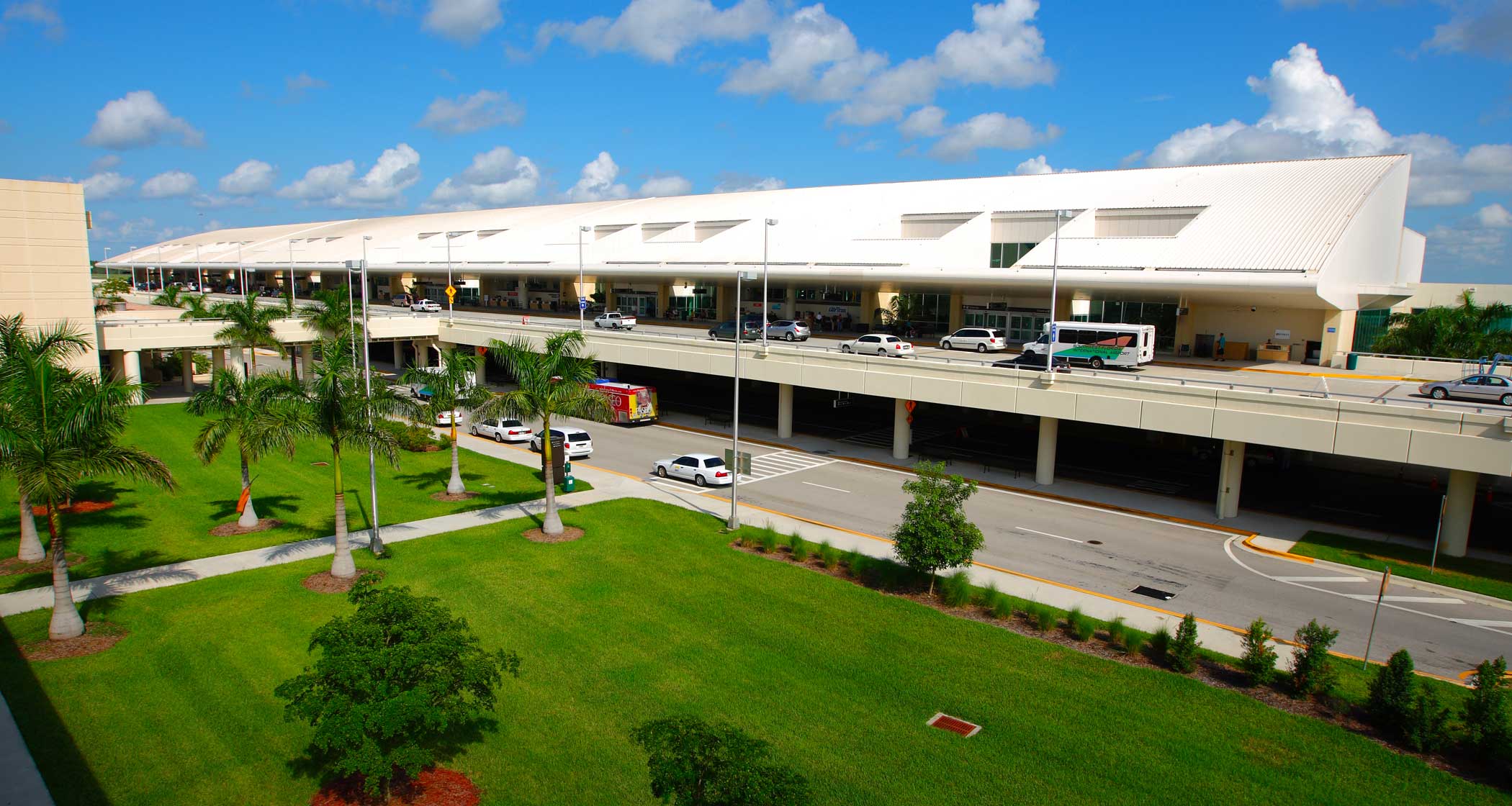 Exterior front facade of airport terminal with two levels.