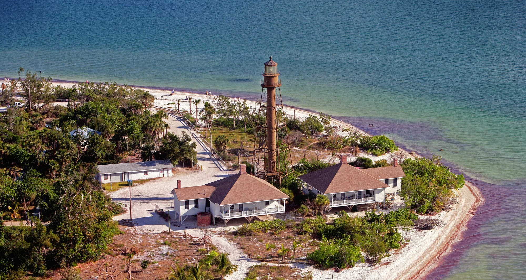 Lighthouse at edge of a beach.