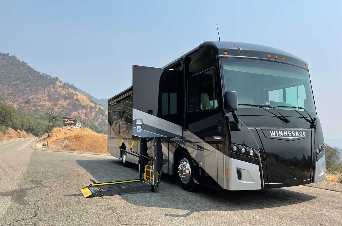 Winnebago Inspire RV in front of Sequoia National Park sign.