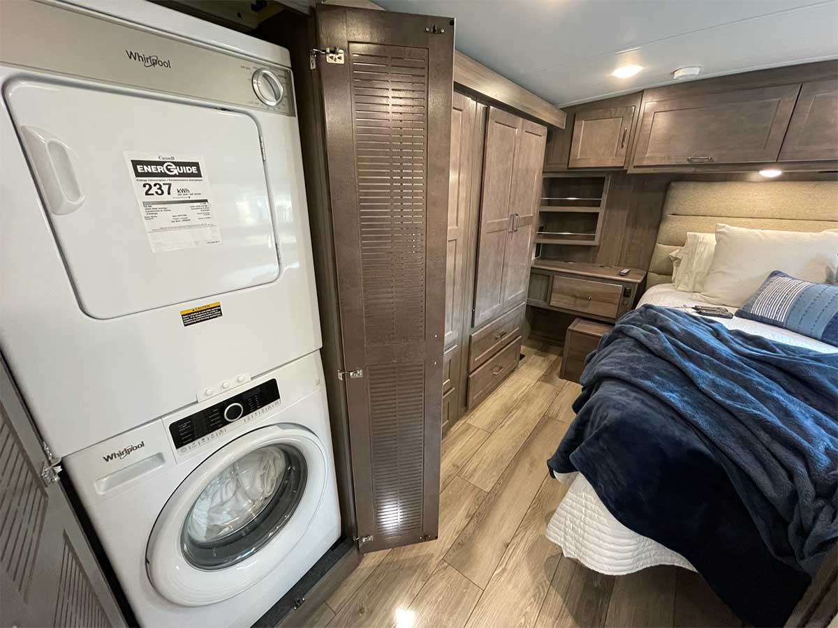 Washer and dryer laundry equipment outside bedroom.