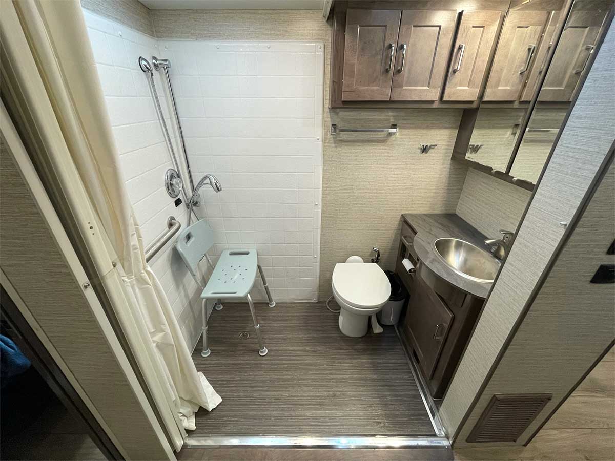 Bathroom with sink, toilet and roll-in shower.