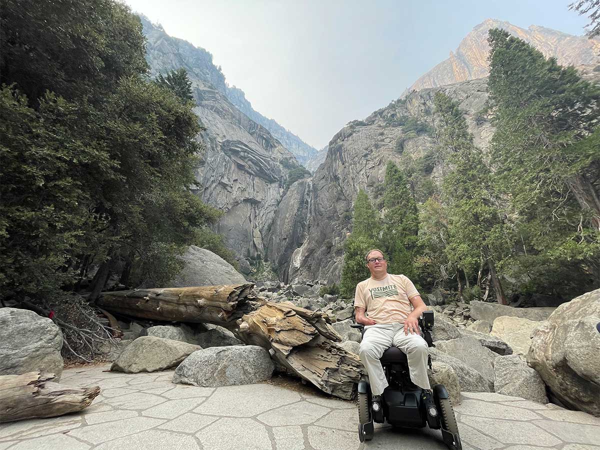 John in wheelchair in front of Lower Yosemite Falls.