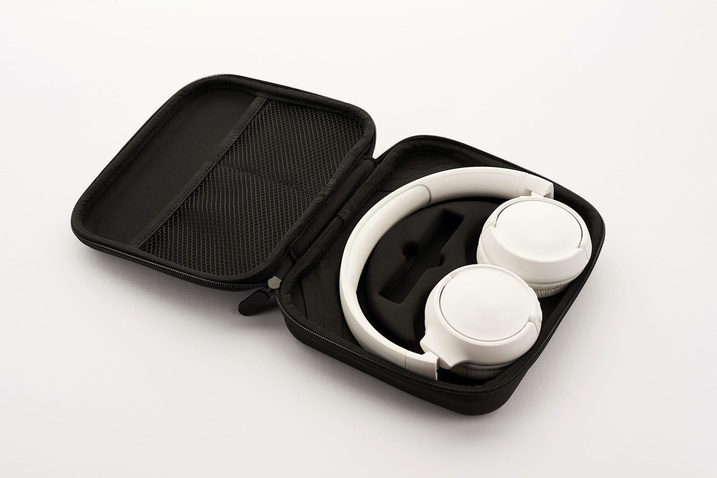 White noise cancelling headphones in a black case.