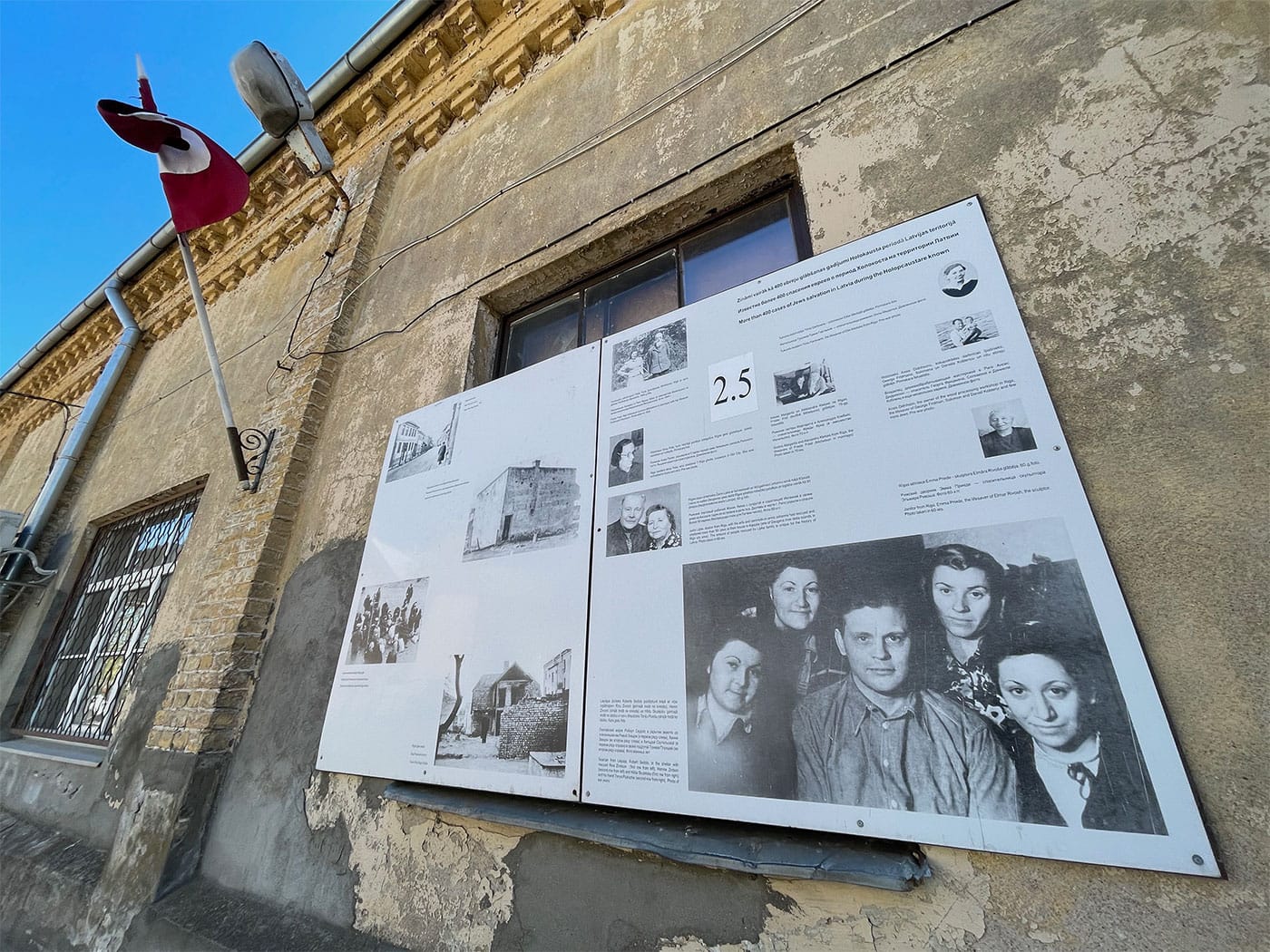 Panel on outside of building with pictures and historical accounts.