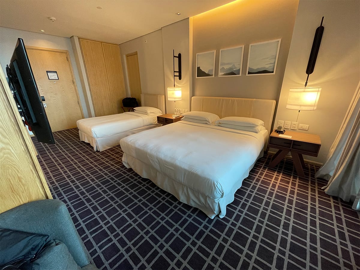 Hotel room with king bed plus a twin or single size bed.