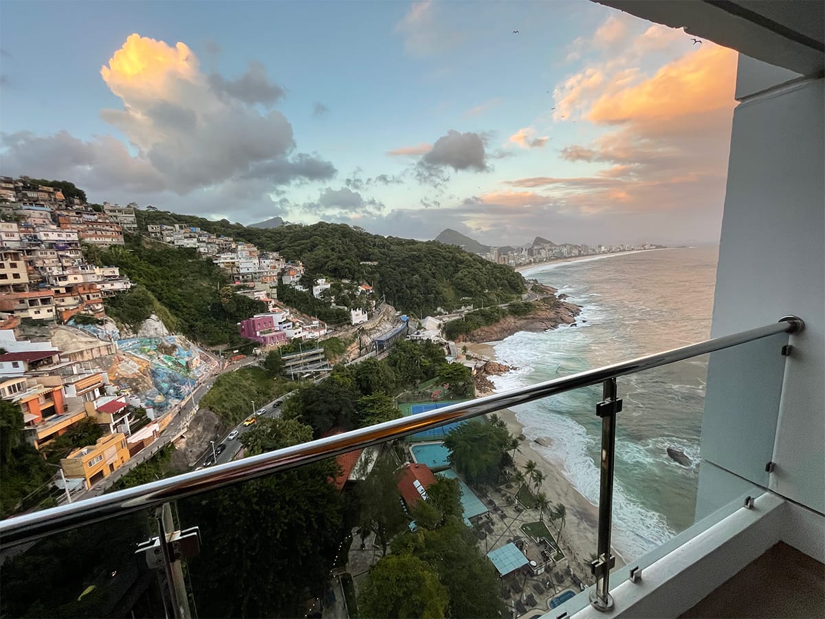 View of hillside and beach from balcony.