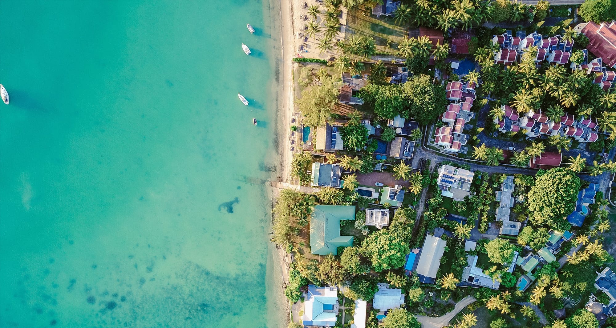 Aerial view of vacation homes along the beach shore.