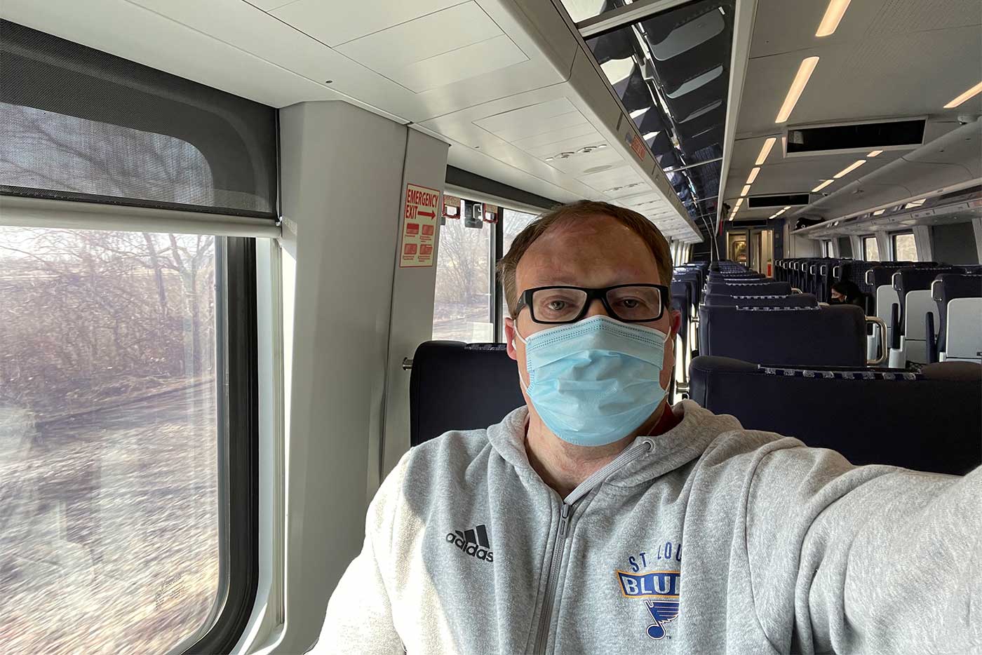 Selfie of John sitting in wheelchair aboard Amtrak venture car train.