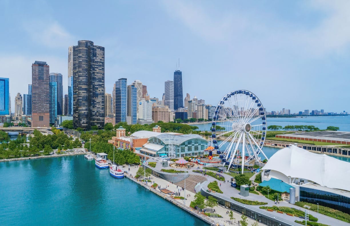 Ferris wheel on Navy Pier with Chicago skyline in the background.