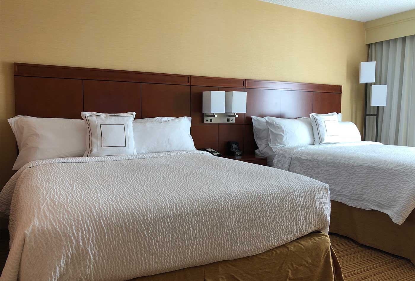 Two queen beds in hotel room.