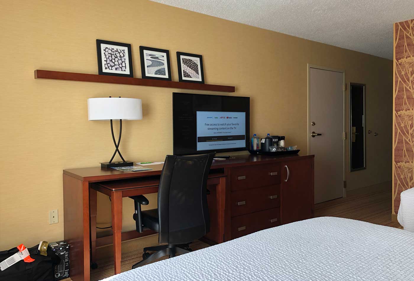 TV and desk across from beds.