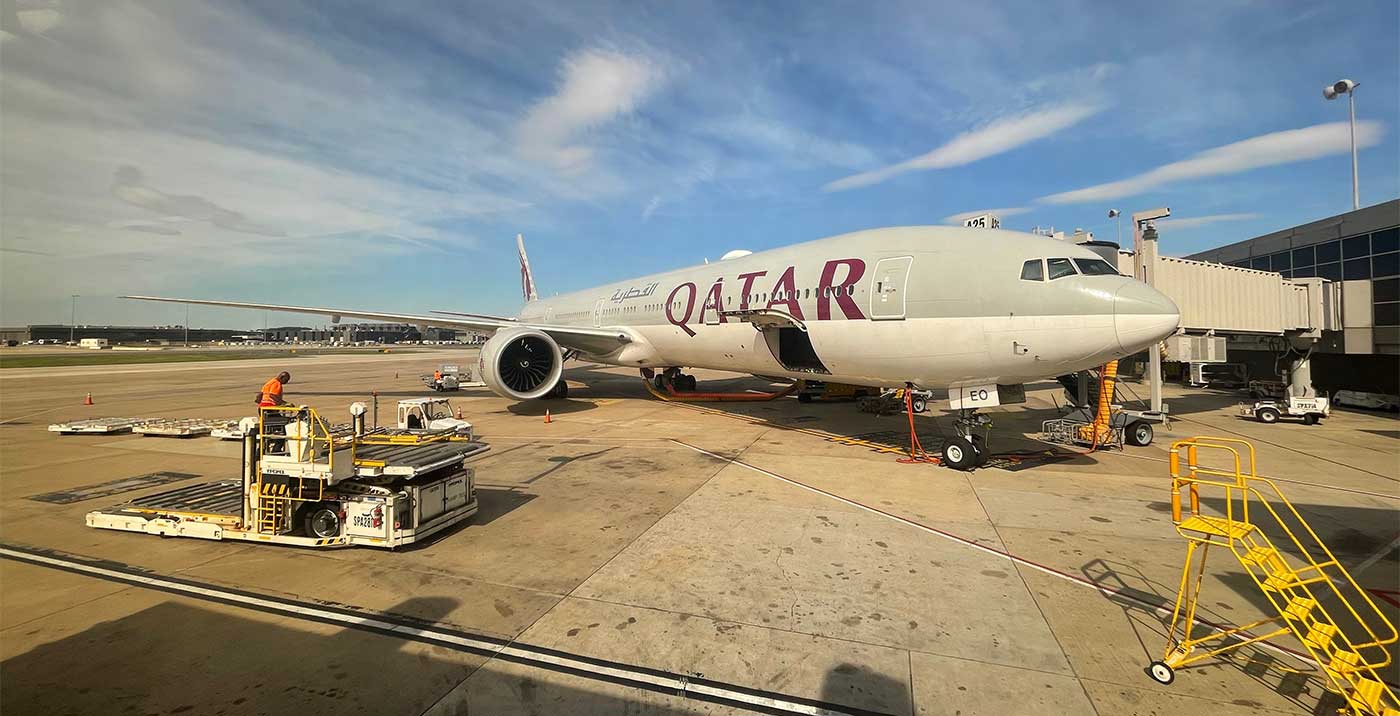 Qatar Airways Boeing 777 aircraft parked at Washington Dulles Airport gate.