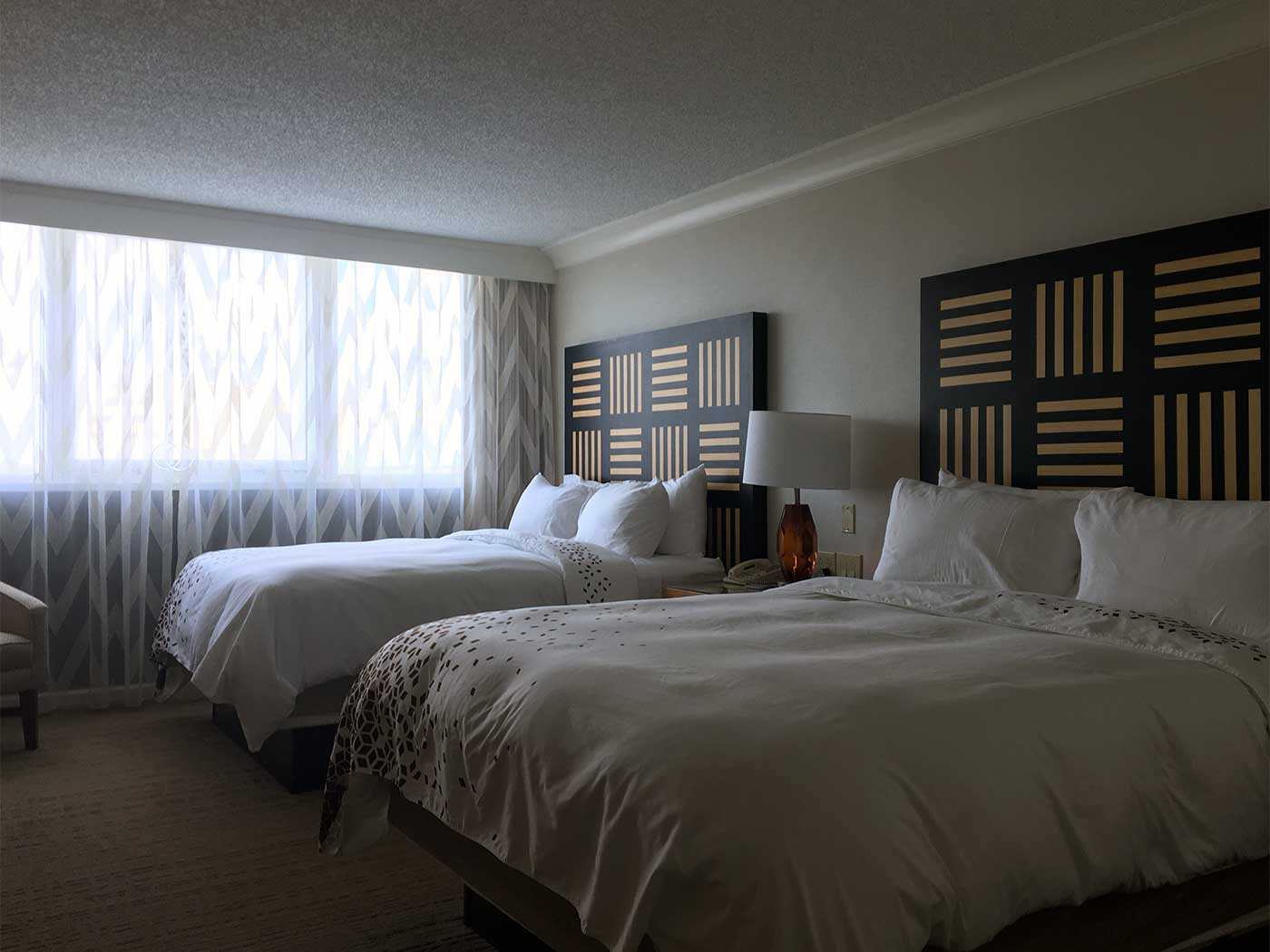 Two queen size beds in hotel room.