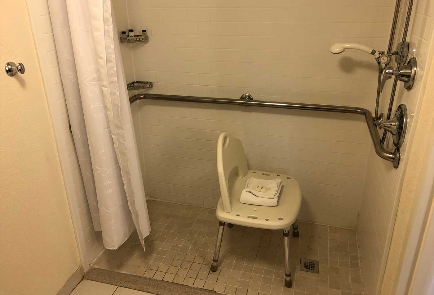 Roll-in shower with portable chair.