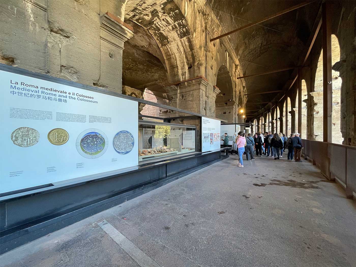 Panels with text in multiple language describing the history of the Colosseum.