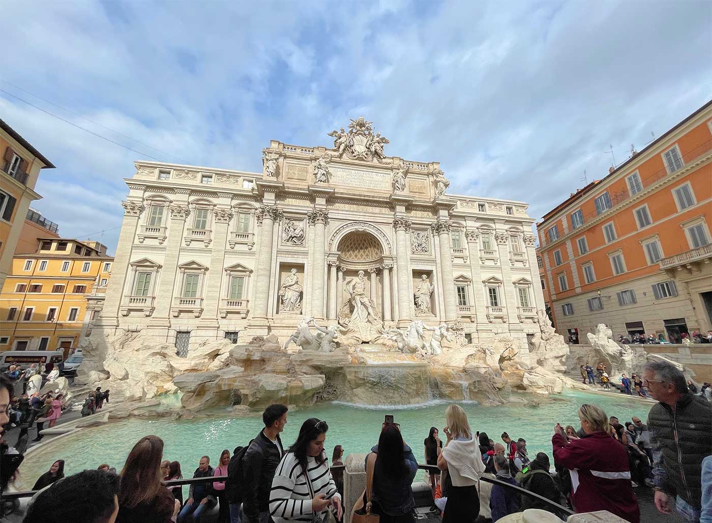 Trevi Fountain set against a blue sky.