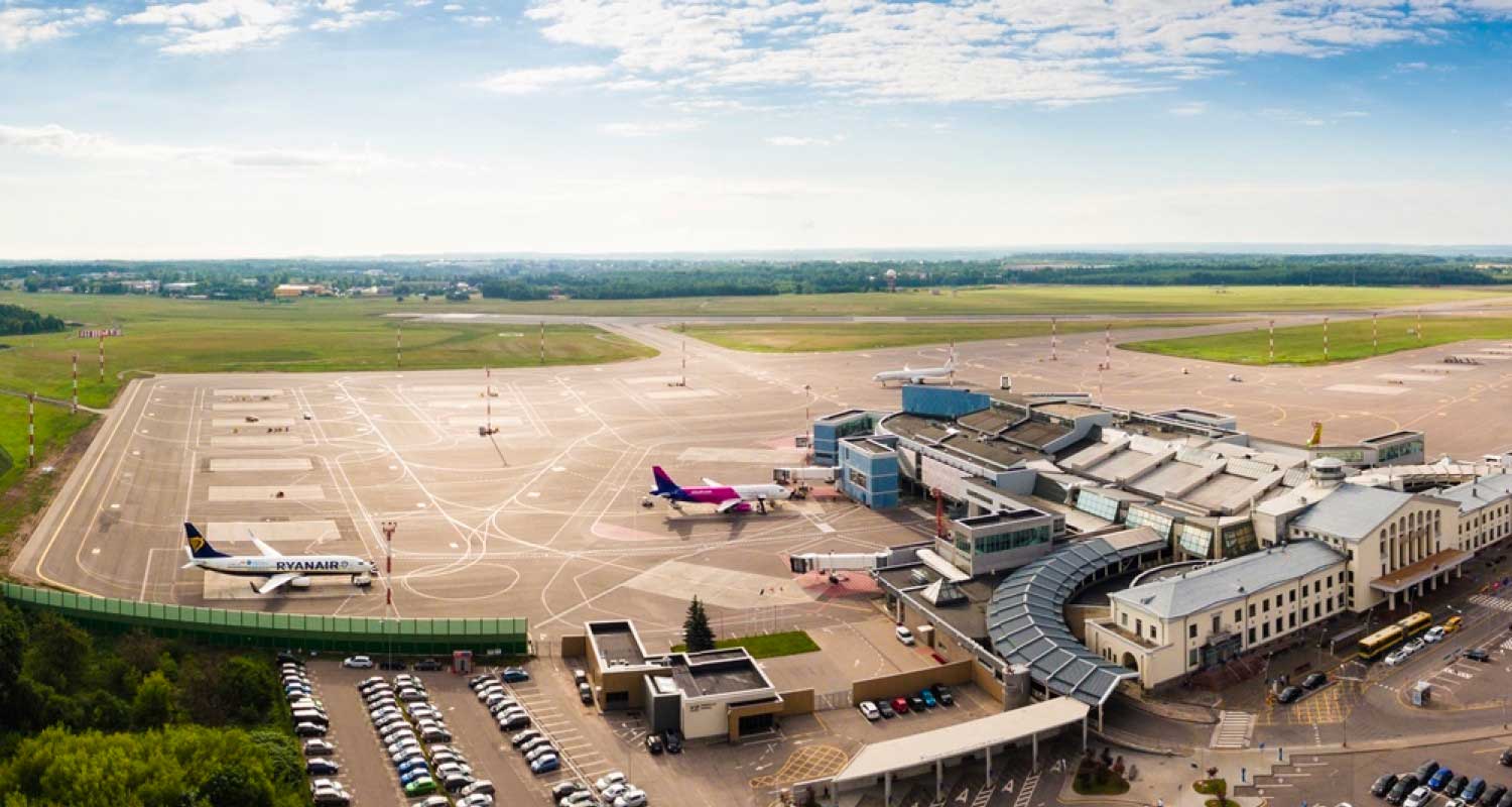 Aerial view of the Vilnius Airport with planes parked at gates.