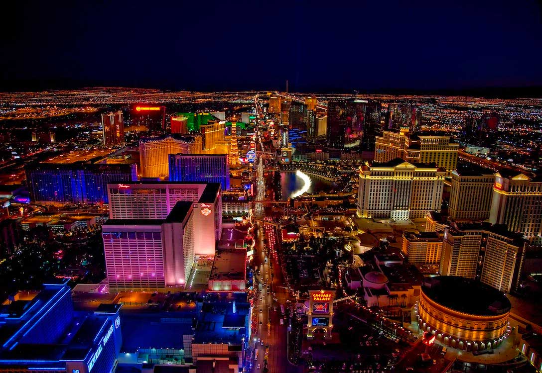 Skyline of the Las Vegas Strip illuminated against the night sky.