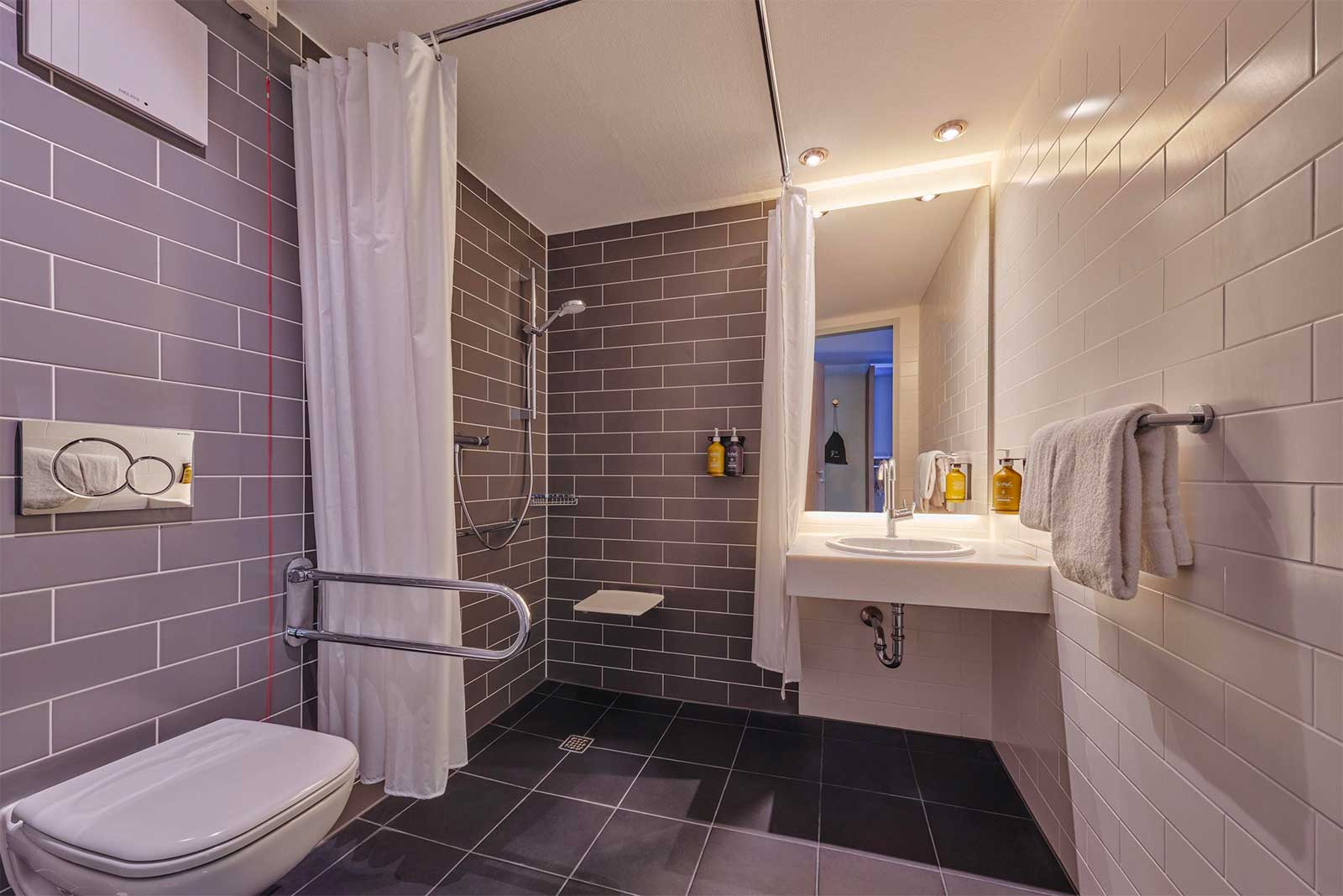 Accessible bathroom with roll-in shower.