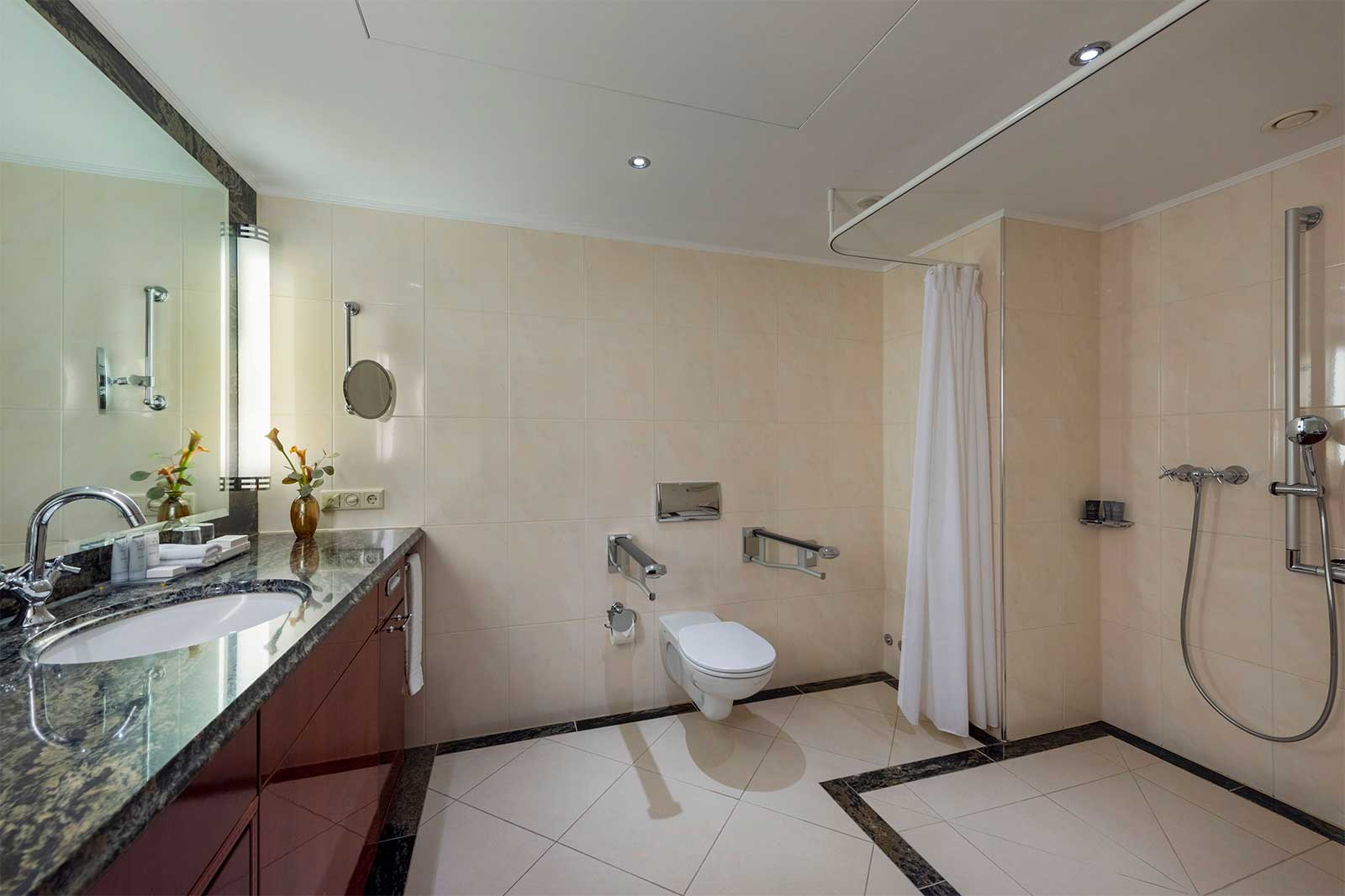 Accessible bathroom with roll-in shower.