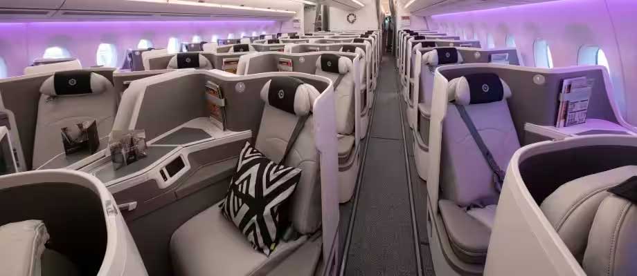 Wide shot of business class cabin seats.