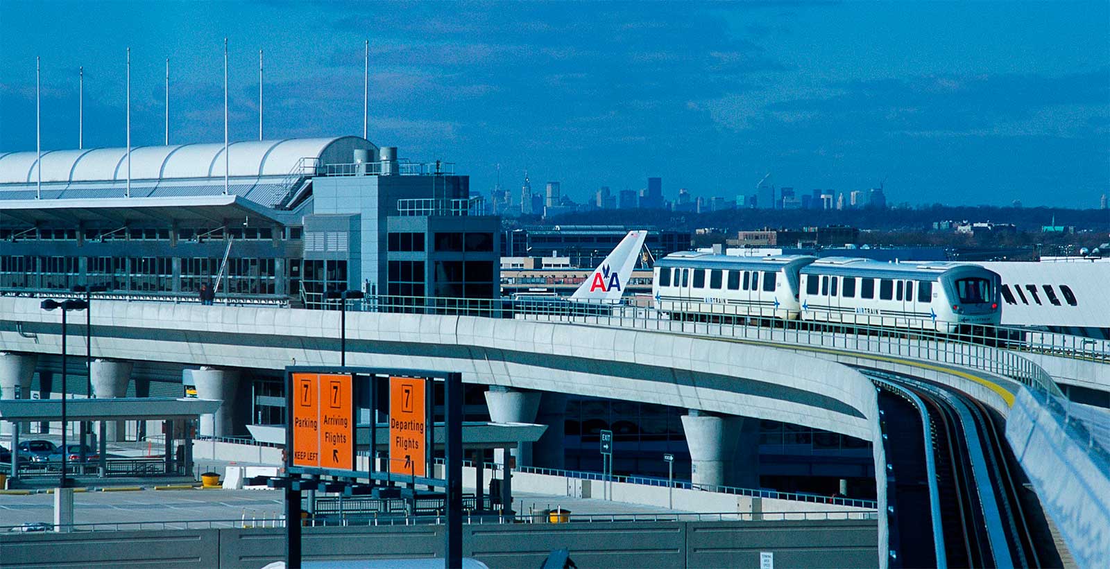 Train on tracks next to JFK airport terminal.