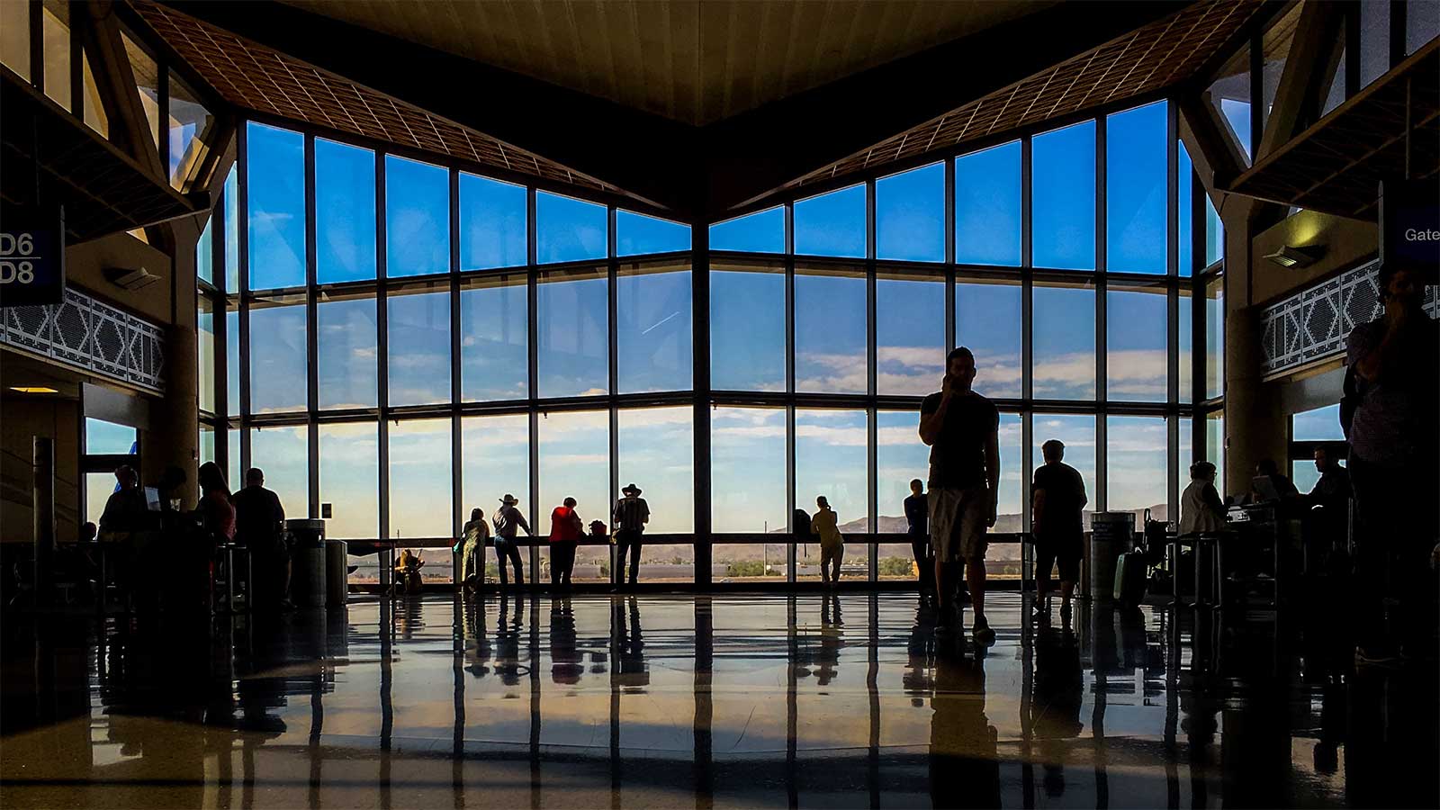 Large glass windows at end of airport passenger terminal.