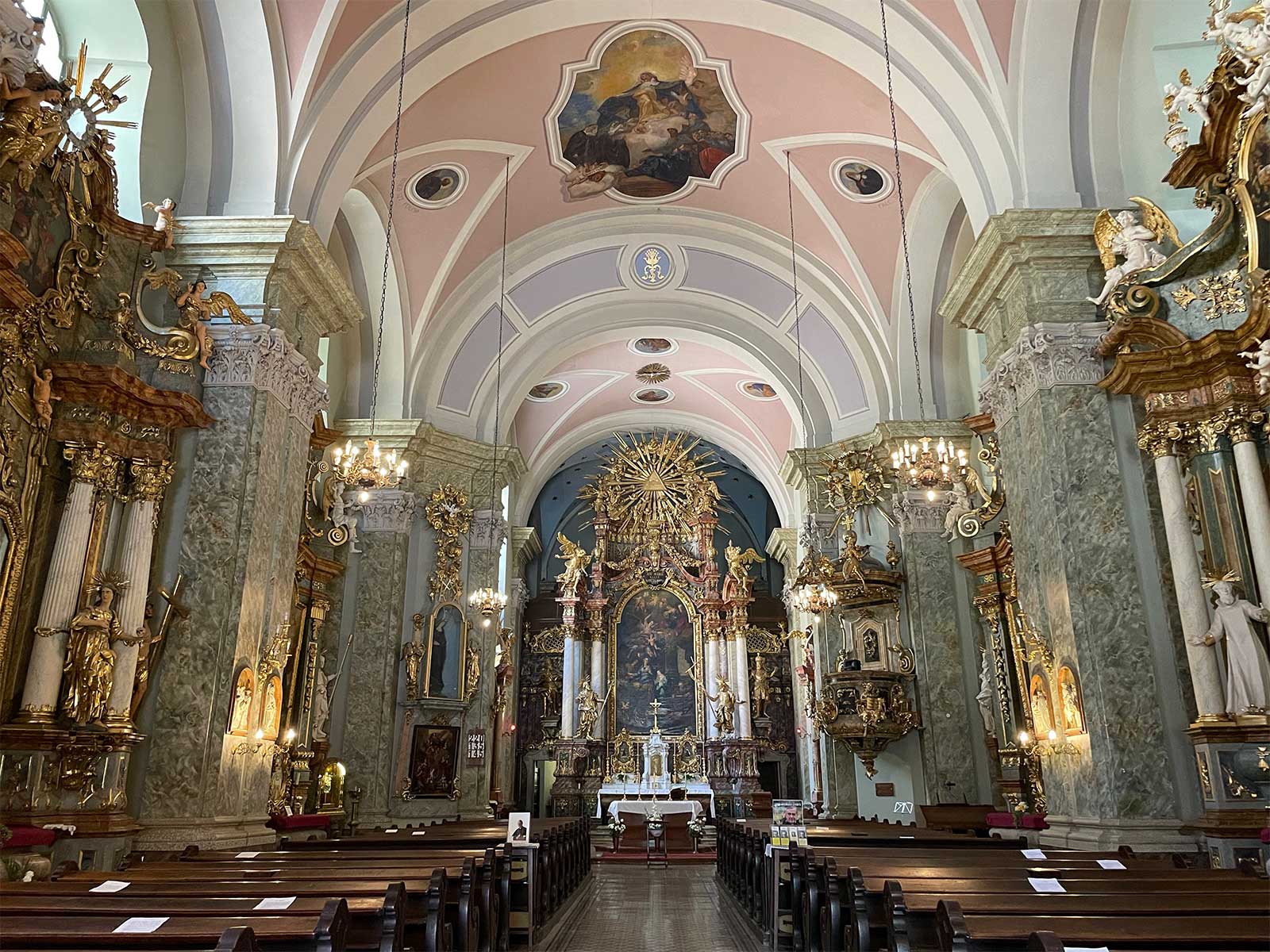 Interior of ornate church sanctuary and altar.