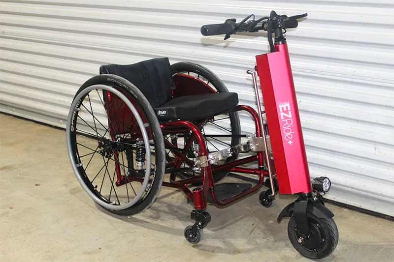 Manual fixed frame wheelchair with easy ride power attachment.