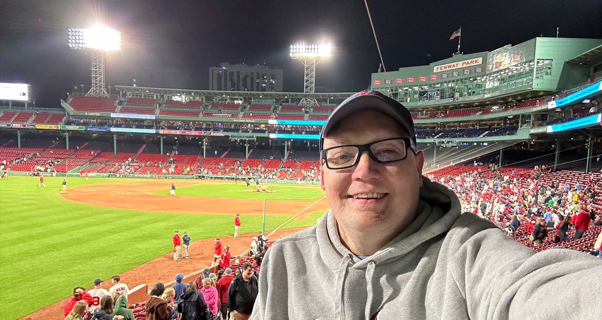 Selfie of John inside Fenway Park at night.