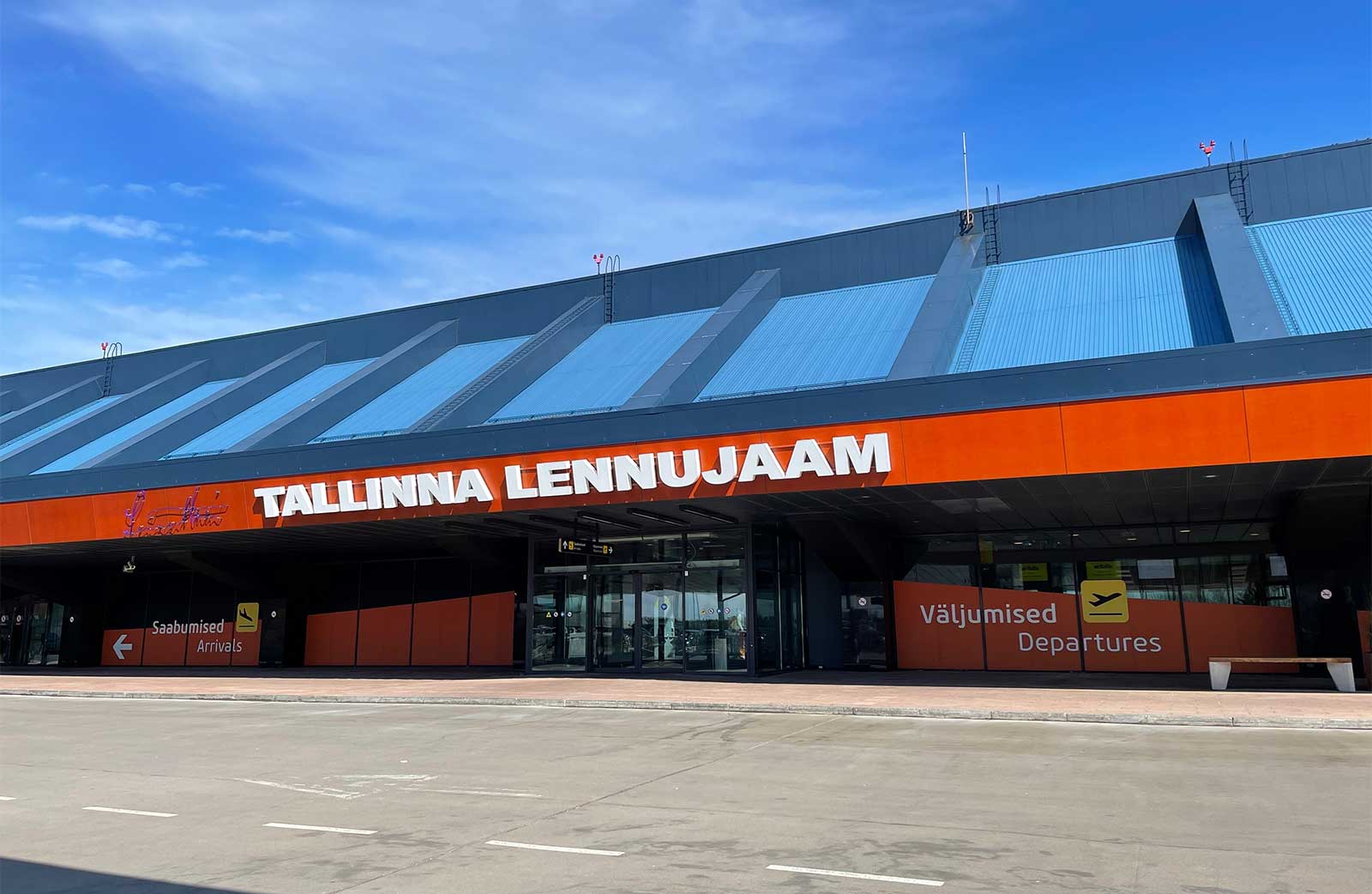 Front facade and passenger drop off area of Tallinn Airport terminal building.