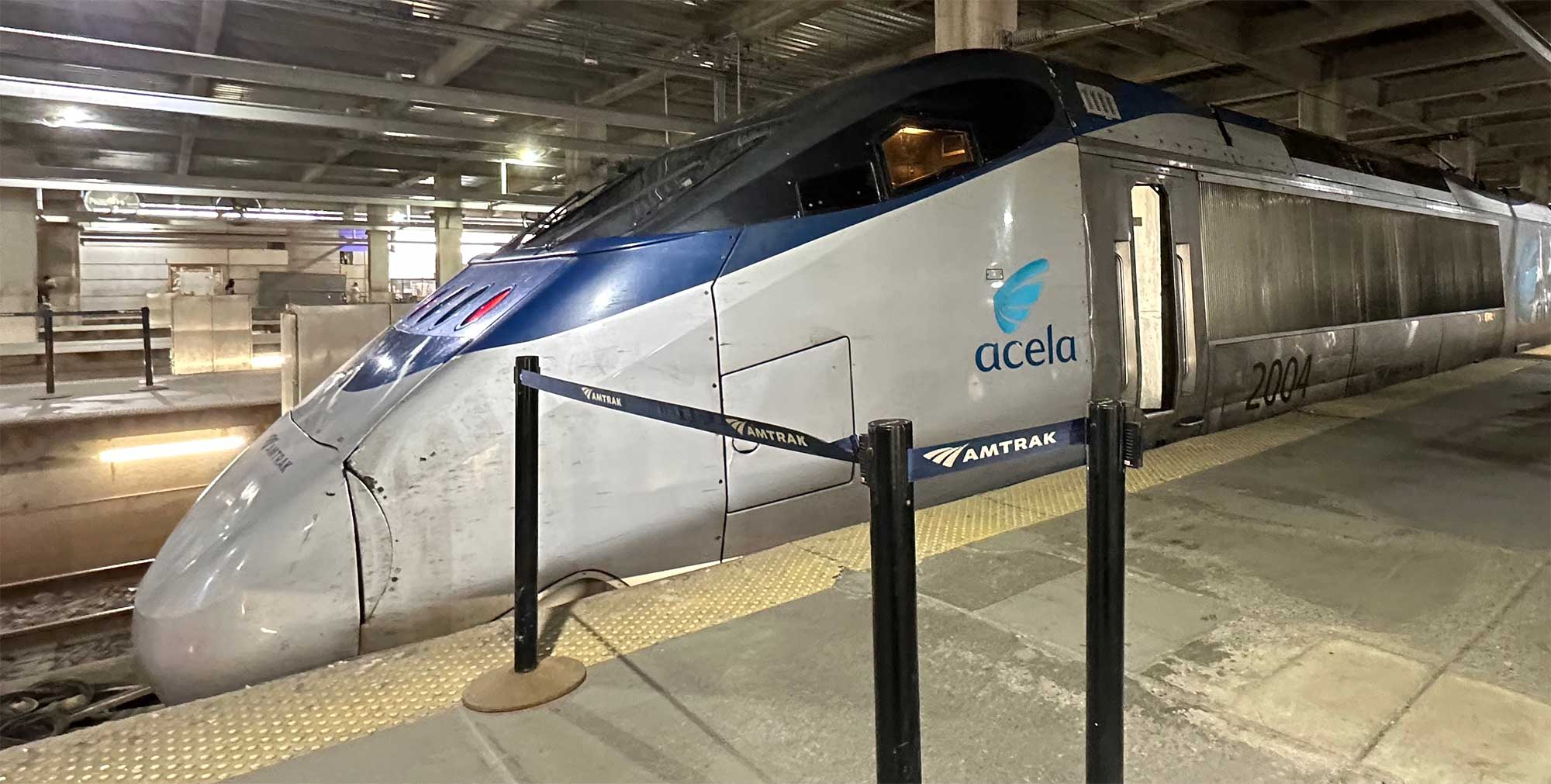 Acela train parked at station.