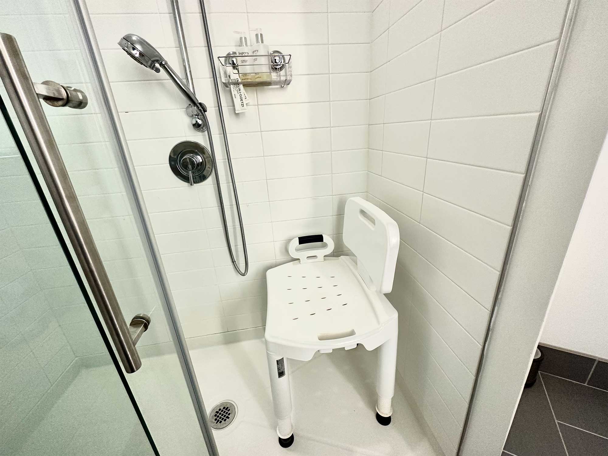 Shower chair inside a walk-in shower.