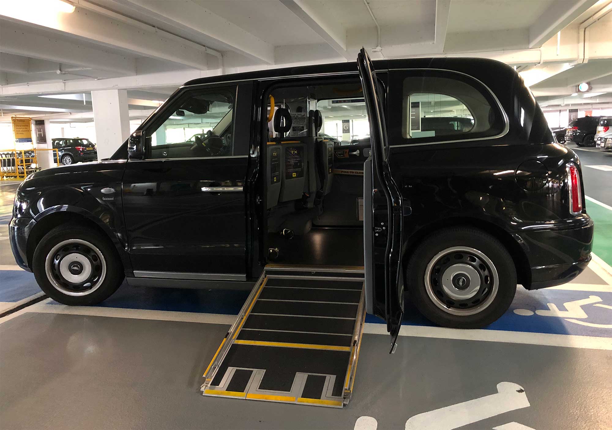 London black cab with wheelchair ramp extended.