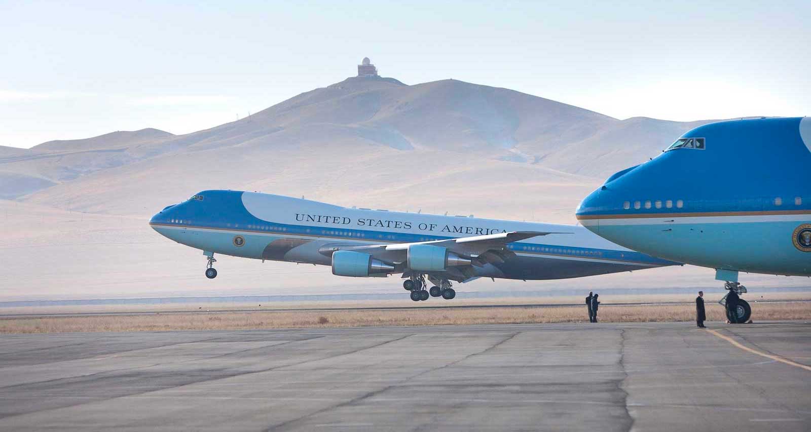 Air4 Force One in the foreground as a second aircraft of the same type takes off in the background.