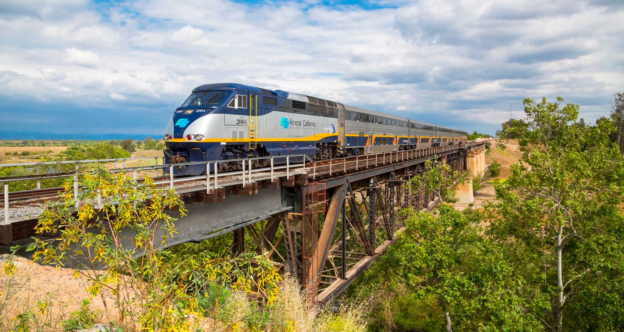 Amtrak California train crossing a bridge.