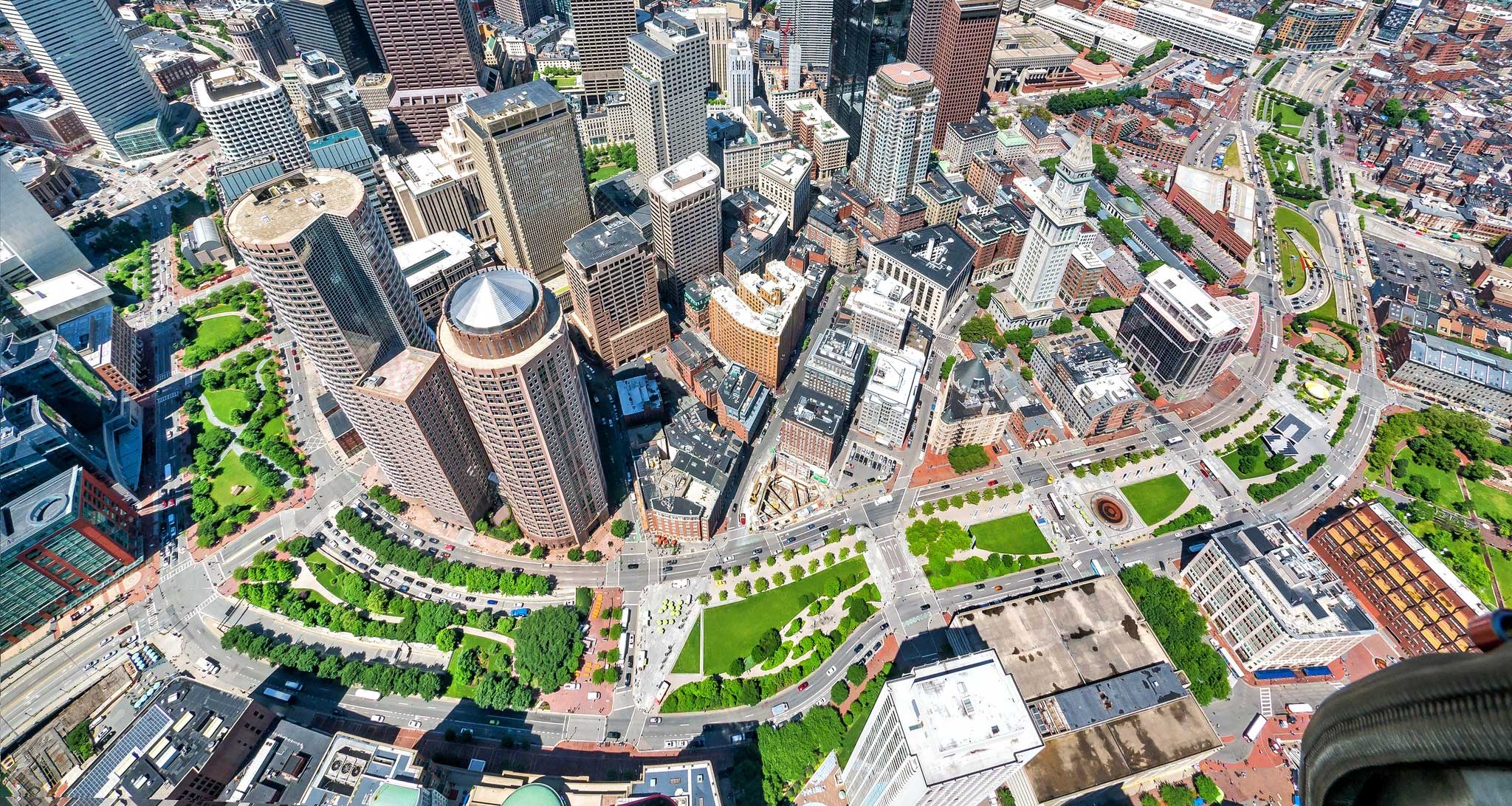 Aerial view of greenway winding through downtown Boston cityscape.