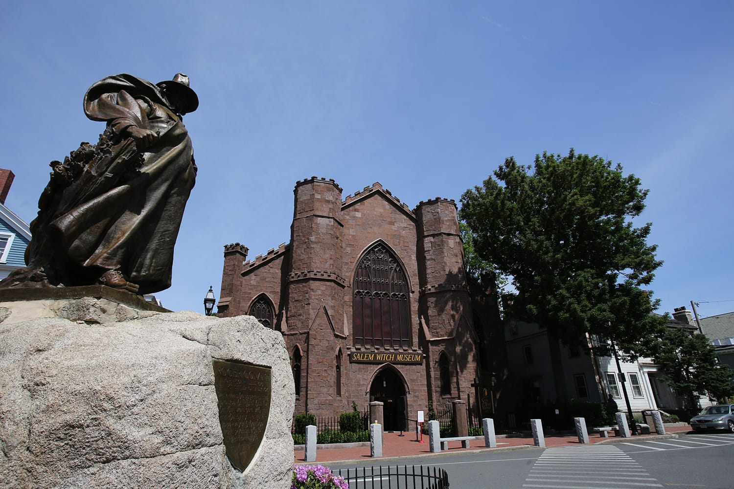 Exterior of brick witch museum building in city square.