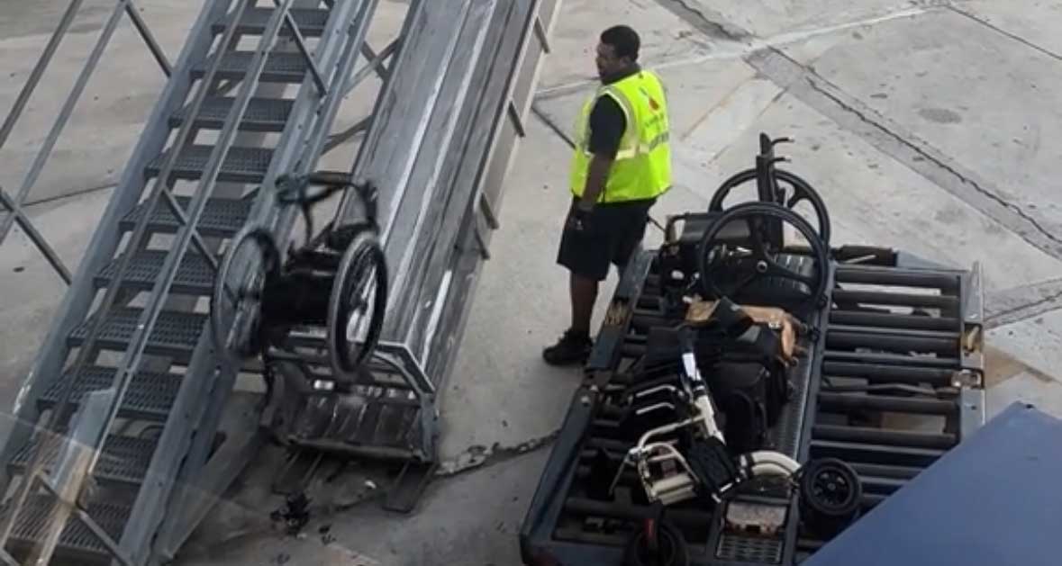 Wheelchair flipping through the air on the airport ramp.