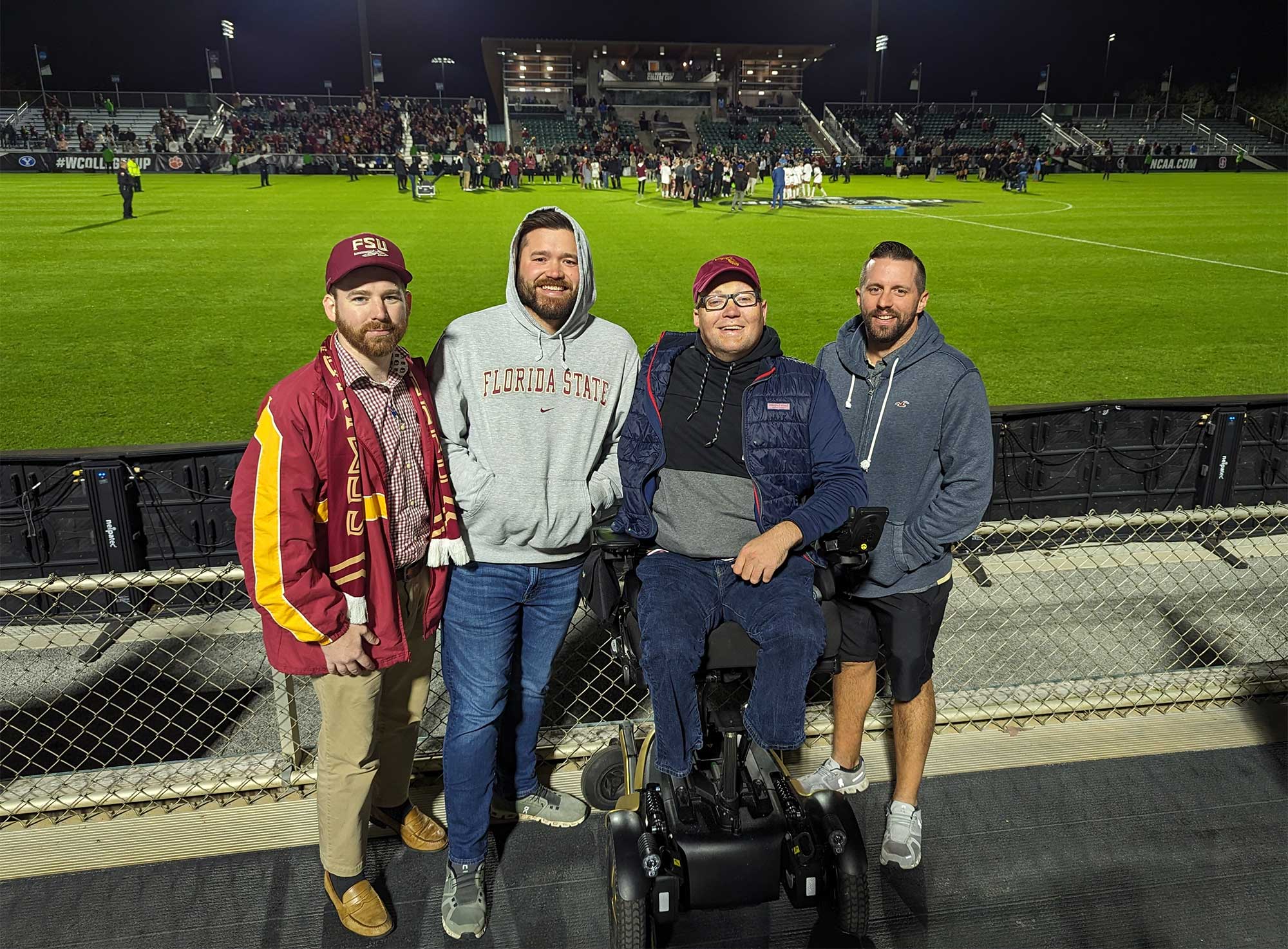 John with friends at a soccer game.