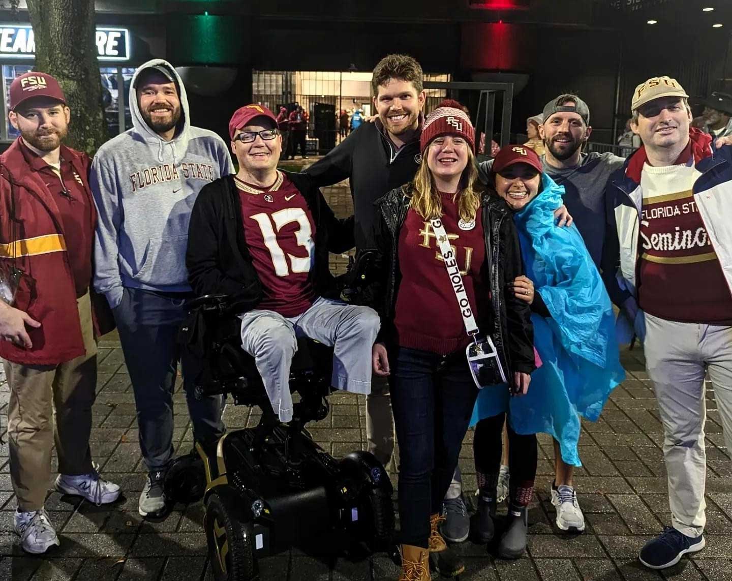 John and a group of friends at a college football game.