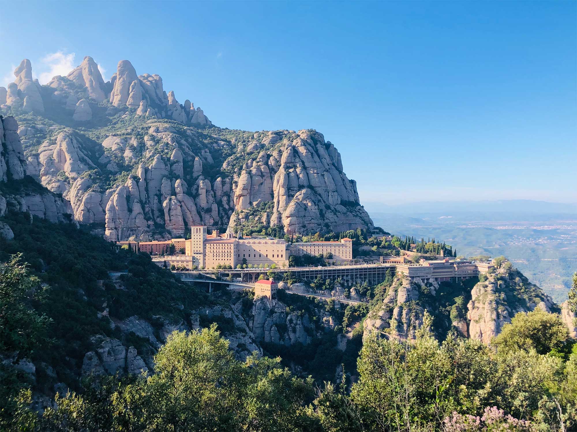 Multi-peaked mountain range with structures built into the side.