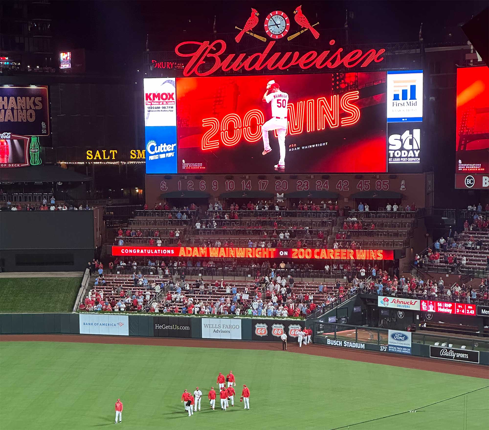 Video board over baseball field showcasing image of pitcher with text 200 wins.